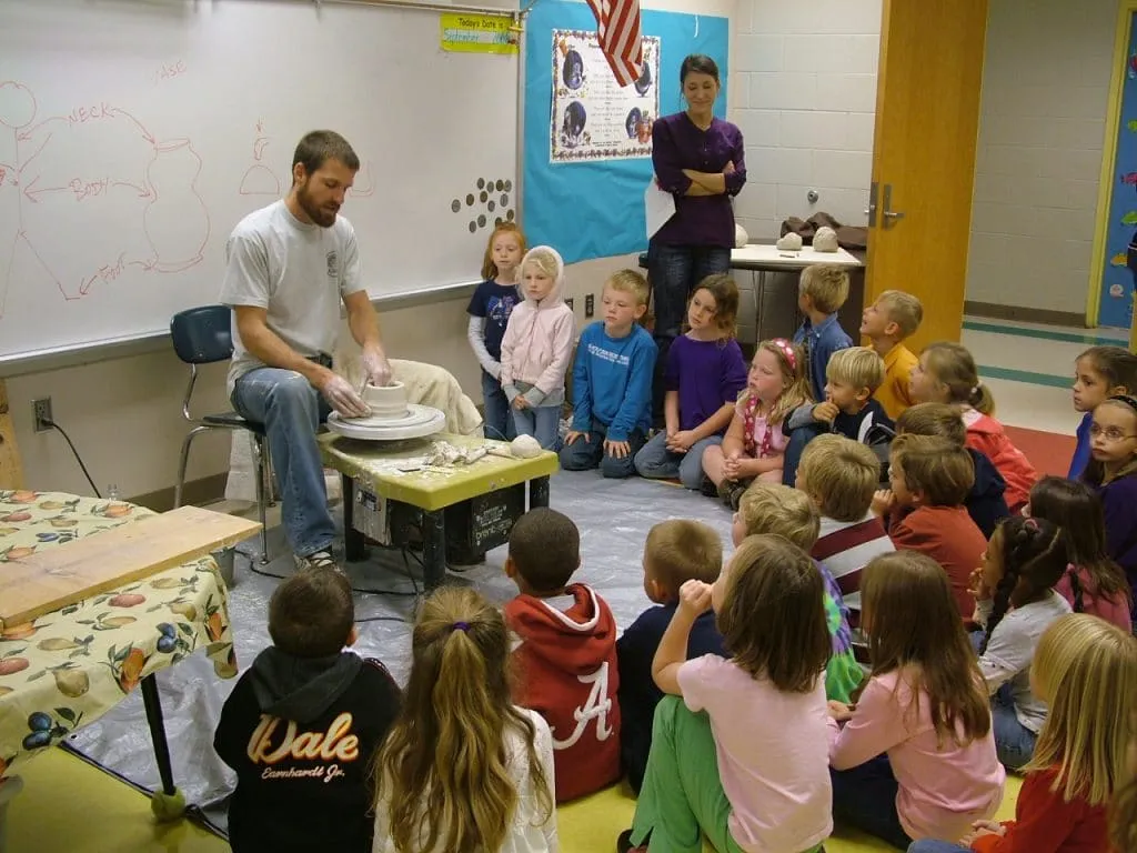 Large-scale metal telescope sculpture installation in outdoor park setting