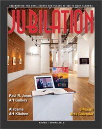 Jubilation magazine cover featuring gallery room with wood floors, white walls, and laptop sitting on pedestal.