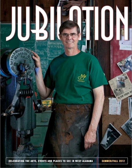 Jubilation magazine cover featuring man wearing green shirt and apron with hand on machinery.