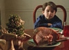 Screen shot of child sitting at table with dinner